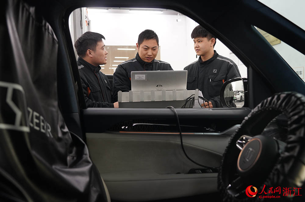 近日，在寧波江北甬江街道一家車企維修車間里，技術(shù)負(fù)責(zé)人向員工講解維修相關(guān)事項(xiàng)。人民網(wǎng) 章勇濤攝